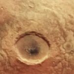 Look at the huge Martian crater that looks like an eerie eye